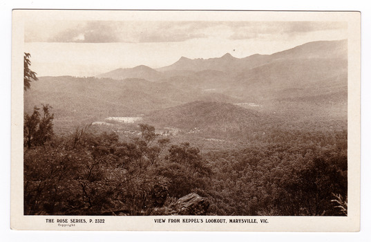 Shows the view of Marysville from Keppel's Lookout near Marysville. Shows the township of Marysville with the Cathedral Range in the background. On the reverse of the postcard is space to write a message and an address and to place a postage stamp. The postcard is unused.