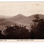 An early sepia photograph of the view of the surrounding mountains taken from Jock's Lookout which is on the Marysville-Wood's Point Road near Marysville in Victoria. Shows heavily forested mountains in the background. On the reverse of the postcard is a space to write a message and an address and to place a postage stamp. The postcard is unused.