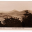 An early sepia photograph of the view of the surrounding mountains taken from Jock's Lookout which is on the Marysville-Wood's Point Road near Marysville in Victoria. Shows heavily forested mountains in the background. On the reverse of the postcard is a space to write a message and an address and to place a postage stamp. The postcard is unused.