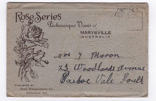 Shows a grey envelope which holds 12 black and white photographs of natural attractions in Marysville and surrounding area. There is an address written on the front of the envelope and a date stamp in the top right hand corner.