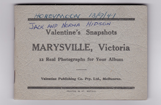 Small, pale grey, card folder with 12 gloss finish photographs of natural attractions in Marysville and surrounding area. The photos have  handwritten style titles in white ink on their lower edge. On the front of the envelope is written 'HONEYMOON 13/9/41' and JACK AND NORMA KIDSON.