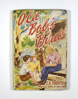 On the front of the dust cover is an illustration of an old man sitting on a bench outside an aviary smoking a pipe and there is a bird sitting on his shoulder. He is talking to two children. On the back of the dust cover is the blurbs of two other novels written by C. K. Thompson.