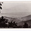 Shows the view of Marysville in Victoria taken from Nicholl's Lookout. In the distance can be seen the buildings of Marysville surrounded by heavily forested mountains. The title of the photograph is handwritten in white ink on the lower edge. On the reverse of the postcard is a space to write a message and an address and to place a postage stamp. The postcard is unused.