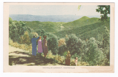 Shows the view of Marysville in Victoria taken from Nicholl's Lookout. Shows two groups of people looking at the view. In the background can be seen a series of heavily forested mountains. The title of the postcard is shown along the lower edge of the postcard. On the reverse of the postcard is a space to write a message and an address and to place a postage stamp. The postcard is unused.