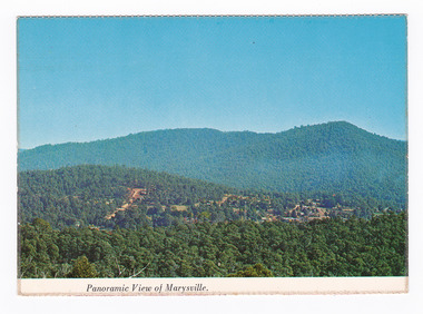Shows the view of Marysville from Barton's Lookout which is near the Cumberland Valley in Victoria. Shows the town surrounded by heavily forested mountains. On the reverse of the postcard is a handwritten message.