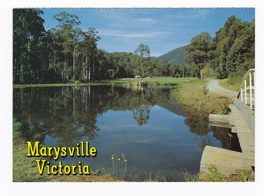 Shows Darmody's Lake in Marysville in Victoria. Shows the lake surrounded by forest and forested mountains. On the reverse of the postcard is a space to write a message and an address and to place a postage stamp. The postcard is unused.