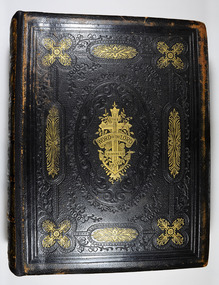 Leather bound with decorative embossing with some in gold on covers and spine.
