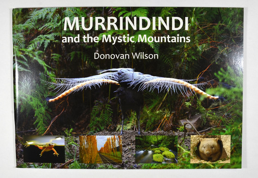 Paperback. Front cover has a large photograph of a lyrebird in full song. Along the lower edge of the front cover are four photographs; a Spotted March frog, the Gould Memorial Drive, a river and a wombat. Back cover has a photograph of the Cathedral Range at dawn.