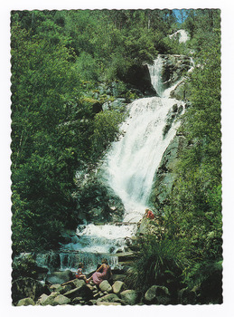 Shows Steavenson Falls in Marysville in Victoria. Shows the falls cascading down the mountain surrounded by forest. At the base of the falls there are a woman and a child sitting on sme large rocks. On the reverse of the postcard is a space to write a message and an address and to place a postage stamp. The postcard is unused.