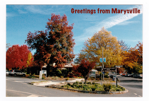 Shows Signpost Corner during Autumn in Marysville in Victoria. On the reverse of the postcard is a space to write a message and an address and to place a postage stamp. The postcard is unused.