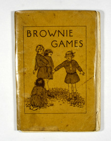 Paperback. Brown cover. Front cover has an illustration of four Brownies playing a game of what appears to be Blind Man's Bluff.