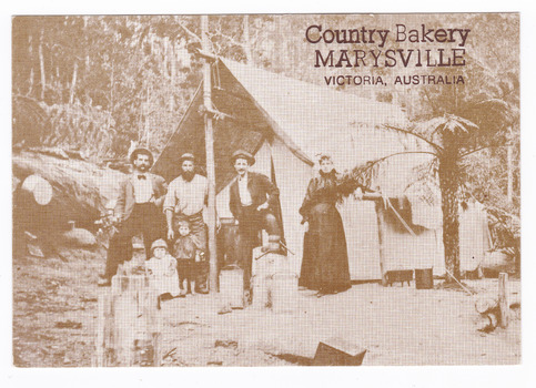 Shows a miner and his family standing outside their tent in the Australian bush. On the reverse of the postcard is a space to write a message and an address and to place a postage stamp. The postcard is unused.
