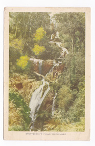 An early colour photograph of Steavenson Falls in Marysville in Victoria. On the reverse of the postcard is a space to write a message and an address and to place a postage stamp. The postcard is unused.