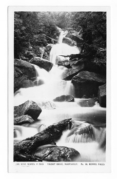 Shows Keppel Falls which is accesible from Lady Talbot Drive. Shows the falls cascading over large rocks through the forest. On the reverse of the postcard is a space to write a message and an address and to place a postage stamp. The postcard is unused.