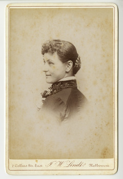 A black and white portrait of an unknown woman taken by John William Lindt. Reverse shows location of John Lindt's studio, his special publications and his various awards and diplomas and the places he won them. Shows also a view of Melbourne, taken by John LIndt.