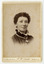 A black and white portrait of an unknown woman taken by John William Lindt. Reverse shows location of John Lindt's studio, his special publications and his various awards and diplomas and the places he won them. Shows also a view of Melbourne, taken by John LIndt.
