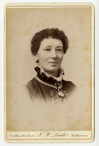 A black and white portrait of an unknown woman taken by John William Lindt. Reverse shows location of John Lindt's studio, his special publications and his various awards and diplomas and the places he won them. Shows also a view of Melbourne, taken by John LIndt.