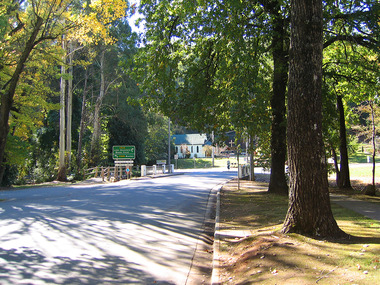 Shows the view looking down Murchison Street in Marysville in Victoria. Shows the F.J. Barton Bridge and the Christ Church on the corner of the Marysville-Buxton Road.