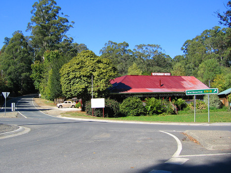 Shows the Crossways Hotel in Marysville in Victoria. Shows a building with a red corrugated iron roof with a sign saying Restaurant Motel on the top.