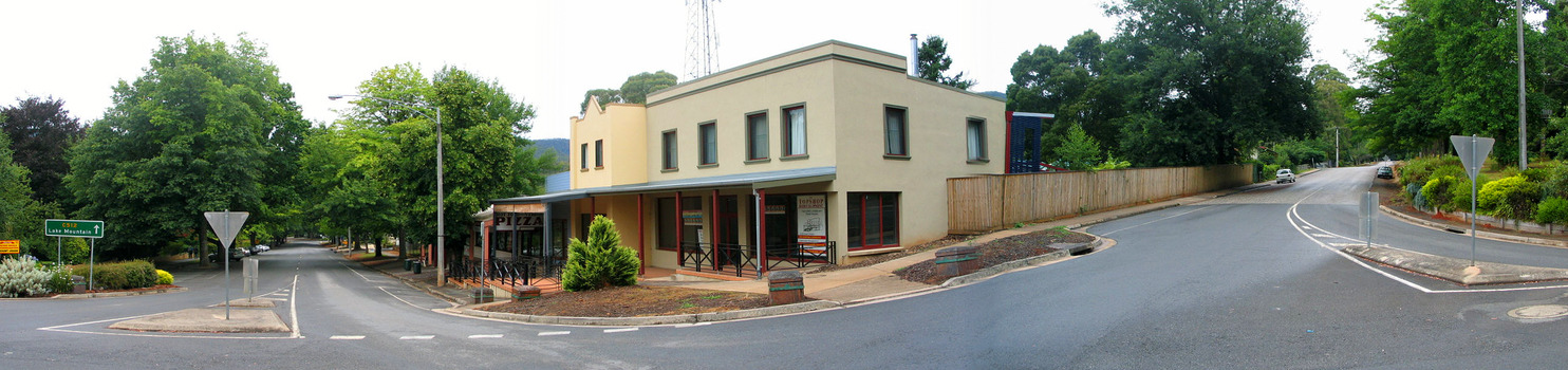 Shows the Top Shop on the corner of Murchison and Lyell Streets in Marysville in Victoria. The view looks down Murchison Street and up Lyell Street. There is also a green sign showing the direction to Lake Mountain.