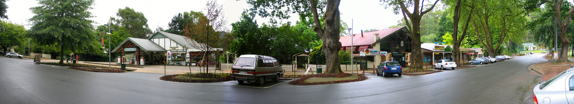 Shows Murchison Street in Marysville in Victoria. Shows the view looking both up and down Murchison Street. In the left of the photograph is the Marysville Hardware Store and in the right is the Cross Country Ski Hire building with more buildings set along the street. In between these two buildings is the entrance to The Lolly Shop.