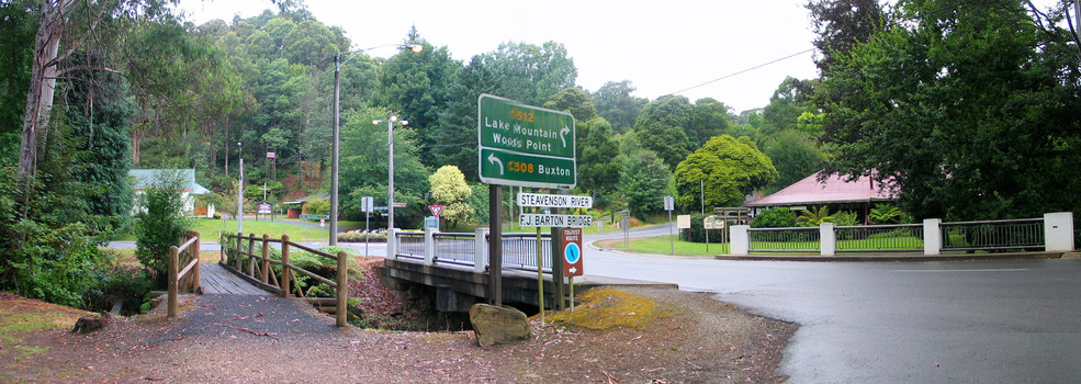 Shows the F.J. Barton Bridge in Marysville in Victoria. In the left of the photograph is Christ Church and in the right is The Crossways Hotel.