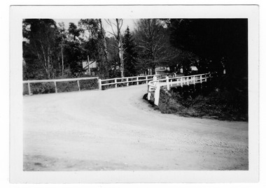 Shows a wooden bridge over the Steavenson River in Marysville in Victoria.