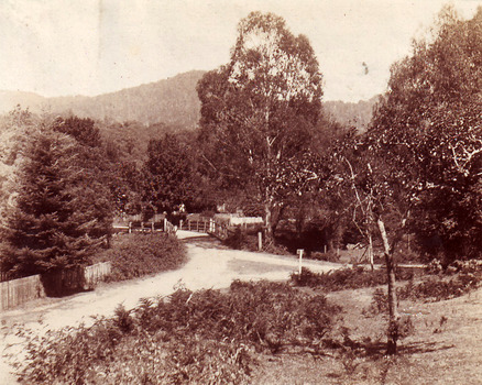 Shows an intersection that leads over a wooden bridge in Marysville in Victoria.