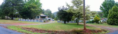 Shows a view on Lyell Street looking at three weatherboard houses, one of which has a wooden picket fence out the front.