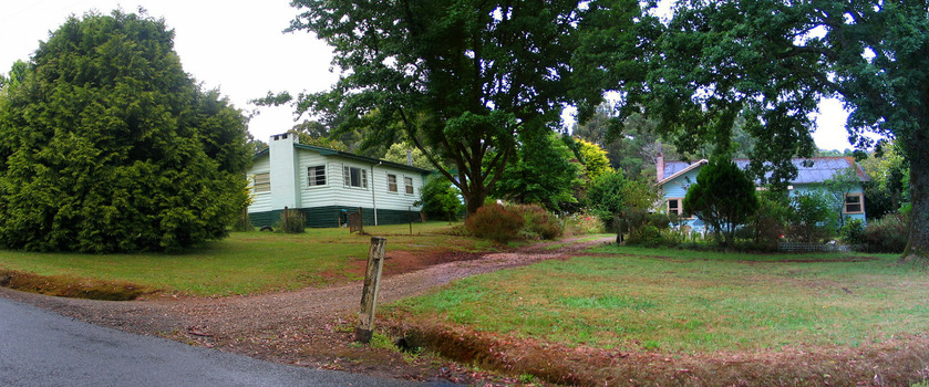 Shows a view on Lyell Street looking at two weatherboard houses.