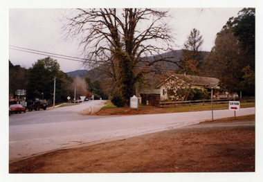Shows the corner of Pack Road and Falls Road in Marysville in Victoria. Shows the brown tourist sign for directions to Steavenson Falls and on the opposite corner is a house with a wooden sign out the front. There are cars parked on the opposite side of the street to the house.