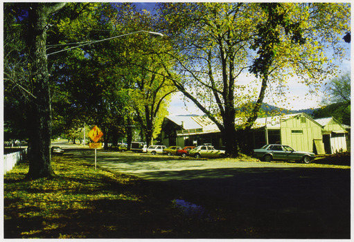 Shows Barton Bros' Store in Marysville in Victoria. Shows several cars parked both in front of the shop and one across the road.