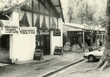 Shows a black and white photograph of The Gallery Restaurant in Marysville in Victoria. Shows a street view looking down Murchison Street.