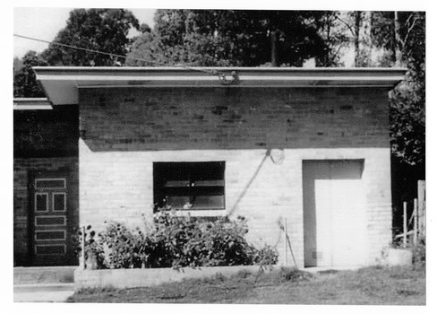 Shows the building that housed the dairy on Falls Road in Marysville in Victoria. Shows a brick building with the front door at the left of the building.