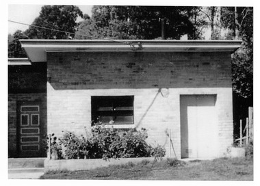 Shows the building that housed the dairy on Falls Road in Marysville in Victoria. Shows a brick building with the front door at the left of the building.