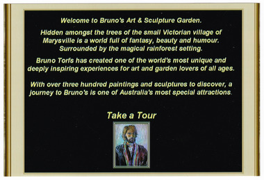 Shows a sign at the entrance to Bruno's Art & Sculptures Garden in Marysville in Victoria. Shows some information about the garden with a small copy of a painting of Bruno on the lower edge.
