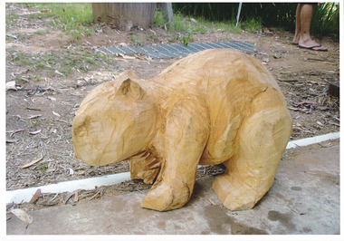 Shows a chainsaw sculpture of a wombat.