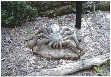 Shows a chainsaw sulpture of a large spider.