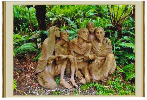 Shows a terracotta sculpture of a group of four adults and a child sitting on the ground. There are two men and two women and they appear to be begging. One of the ladies is wearing a shawl over her head. Two of the figures appear to be looking at someone above them. 