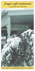 Shows a sign under a verandah advertising the cafe restaurant. In the foreground is a small shrub covered in snow. On the reverse is a list of goods and produce available in the cafe. Also shows opening hours and a telephone number.