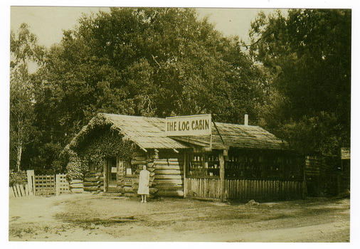 Shows The Log Cabin in Marysville in Victoria. Show a lady standing out the front of the building.