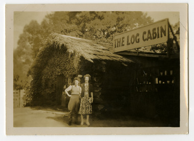Shows two ladies standing outside The Log Cabin in Marysville in Victoria. One of the ladies is wearing jodphurs.