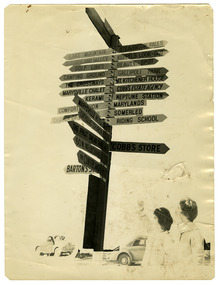 Shows a wooden signpost with signs showing the direction of various accommodation locations and local attractions in Marysville and the surrounding district. Shows two ladies standing at the bottom of the signpost looking at the signs. There are two cars parked at the base of the signpost.