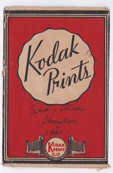 Shows an envelope that was used to present photographs or negatives after they were developed and printed. Envelope is red with the Kodak symbol on the lower edge. Reverse has a Kodak symbol with the various films that were available at the time. Shows as well the various addresses of Kodak in Australia.