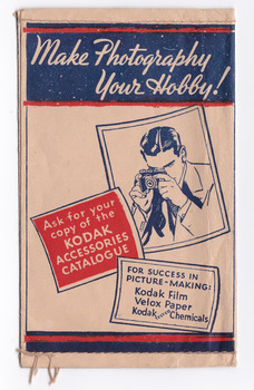 Shows the title on the upper edge. Shows a cartoon drawing of a man taking a photograph. Shows a red square with the words "Ask for your copy of the Kodak Accessories Catalogue". Shows another square with the words "For success in picture-making: Kodak film , Velox Paper, Kodak Tested Chemicals.