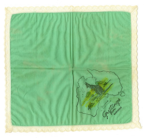 Shows a green souvenir handkerchief. Handkerchief is light green in colour with white lace surrounding the edges. In one corner is a printed map of Australia with a kangaroo sitting in a scene of grasslands and trees. Below the map is the words "Souvenir of Australia. Greetings from Marysville".