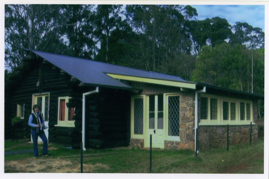 Shows The Log Cabin in Marysville in Victoria. Shows a lady wearing jeans standing out the front of the building.