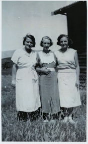 Shows members of the Branchflower Family in Marysville in Victoria. Shows three women standing alongside each other, posing for the photograph.