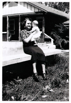 A black and white photograph of Mrs Wykeham Perry Snr nursing her son, Wykeham Perry Jnr.