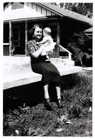 A black and white photograph of Mrs Wykeham Perry Snr nursing her son, Wykeham Perry Jnr.